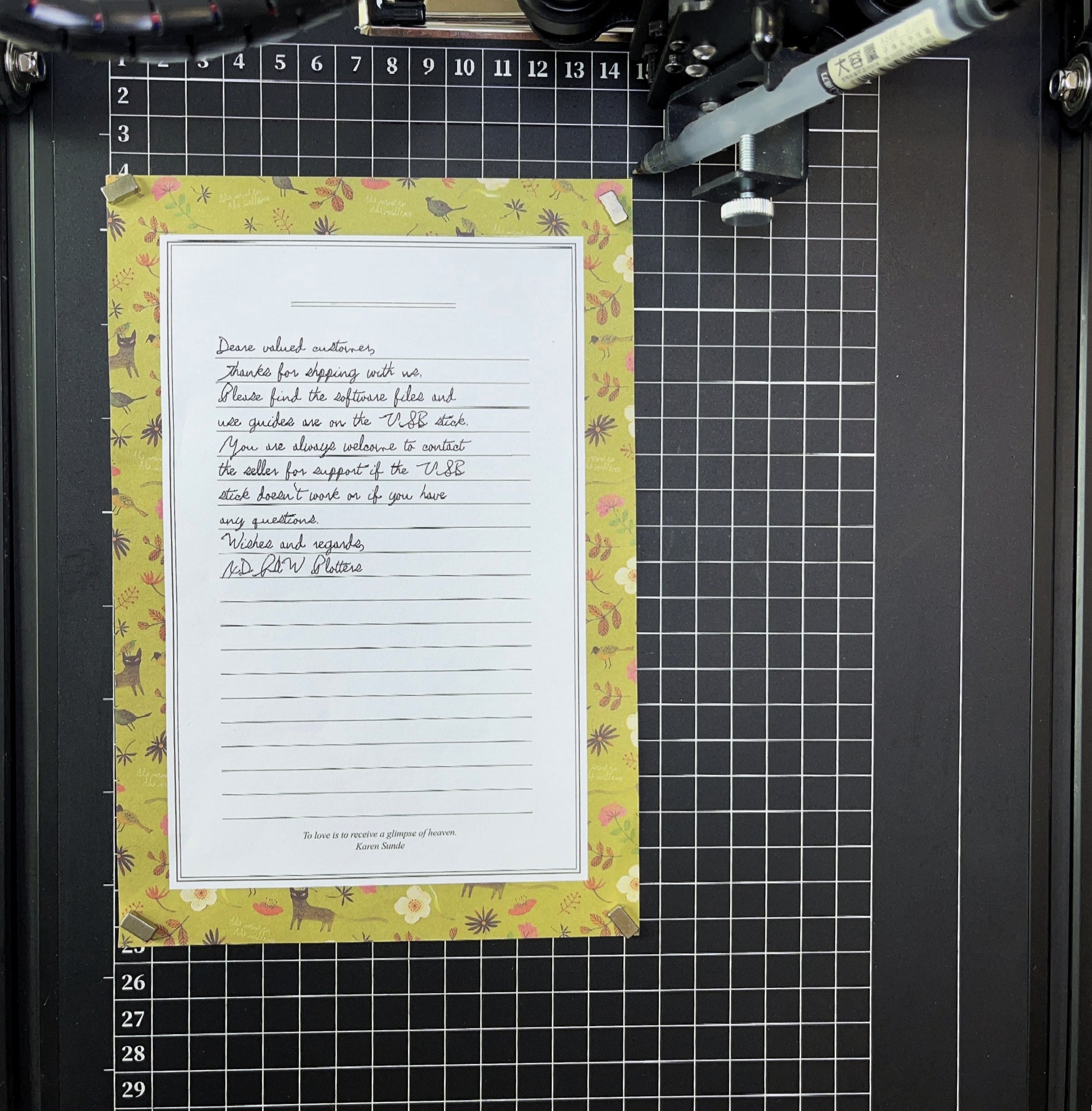 Pen plotter demonstration showing handwritten letter output on A4 paper with authentic ink